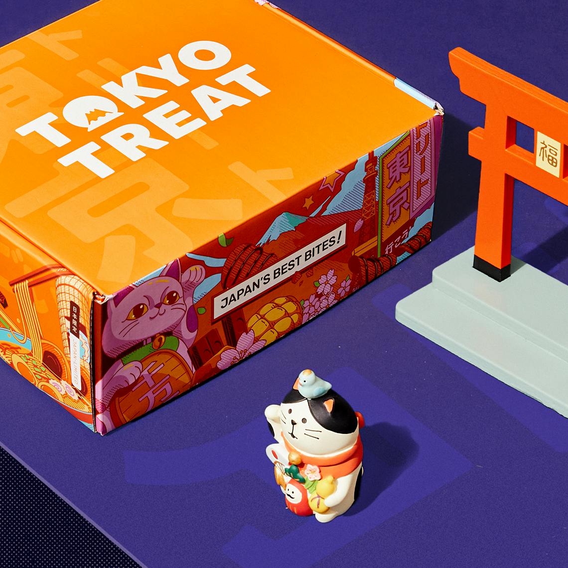 The TokyoTreat box on a blue background with New Year's props.