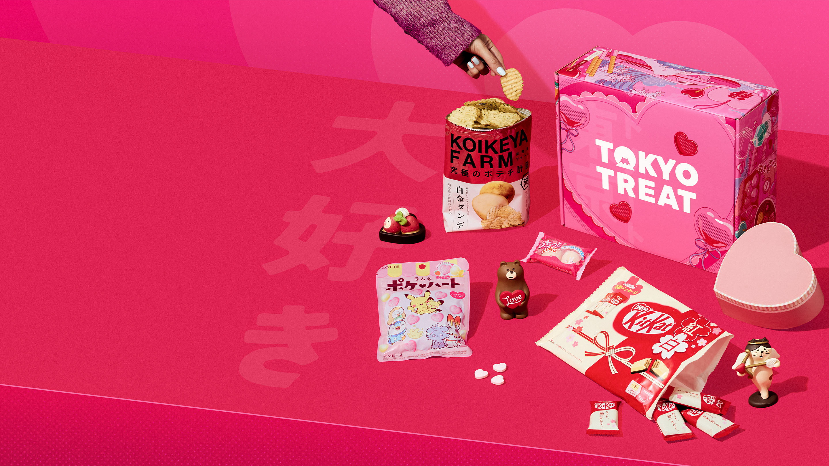 TokyoTreat's delicious Valentine's Day box surrounded by Japan-exclusive snacks like KitKats, chips, and candy.