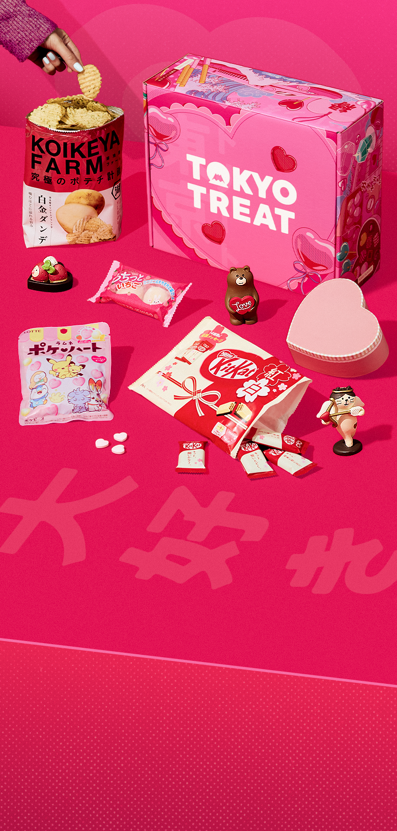 TokyoTreat's delicious Valentine's Day box surrounded by Japan-exclusive snacks like KitKats, chips, and candy.