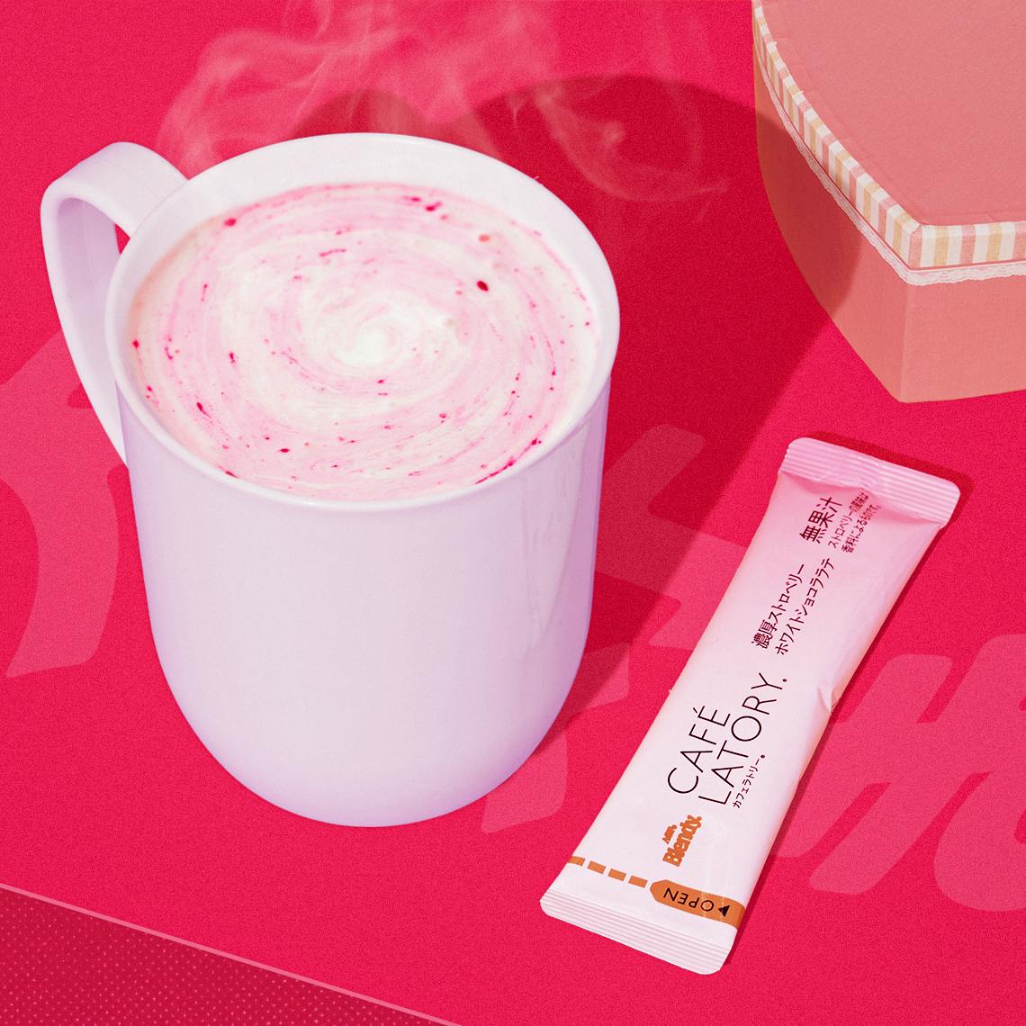 White Chocolate Strawberry Latte in a white cup on a red background.