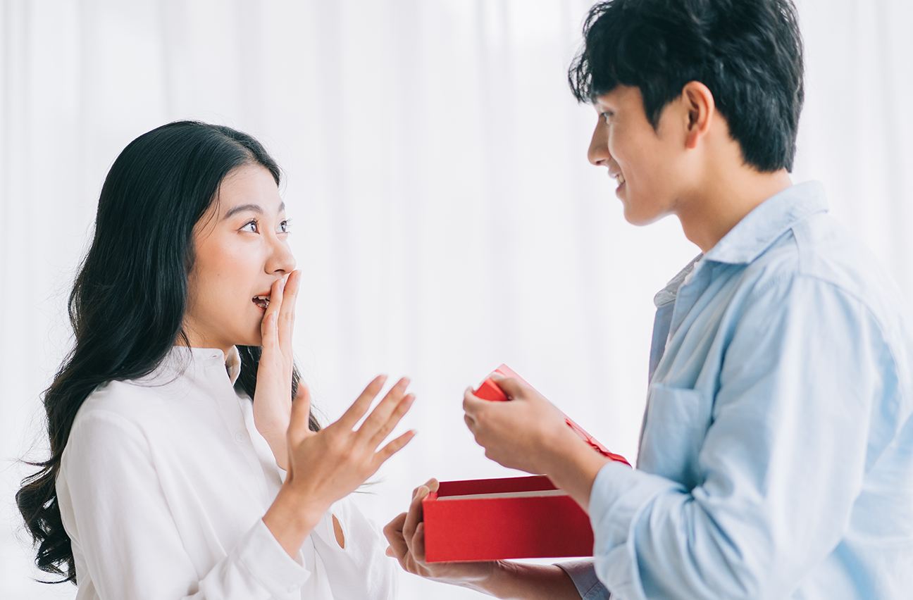 A guy and girl exchanging Valentine's chocolates.