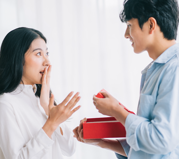 A guy and girl exchanging Valentine's chocolates.