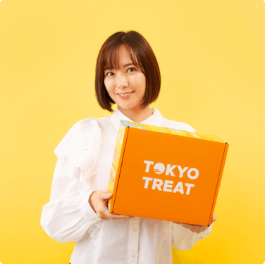 TokyoTreat CEO Ayumi Chikamoto holding a TokyoTreat snack box.