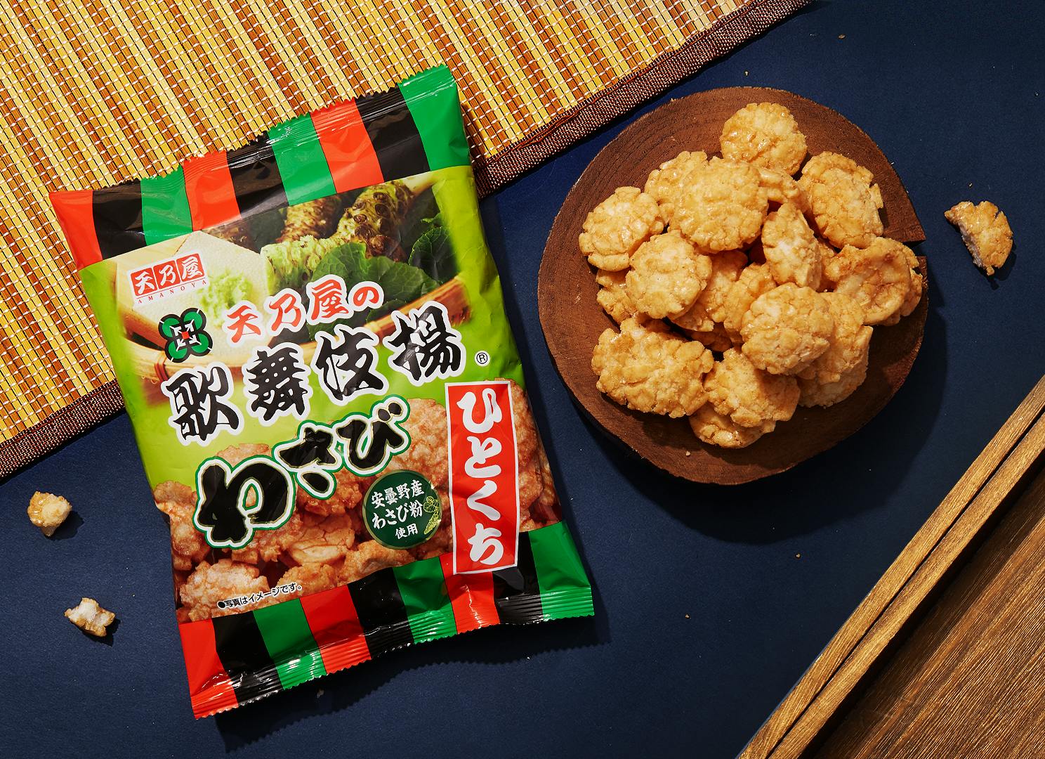 Kabuki Wasabi Rice Crackers sits on a blue backdrop, surrounded by Japanese traditional elements.