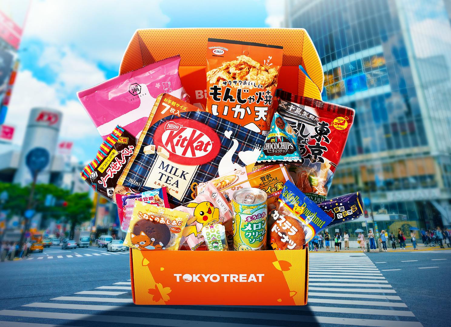 The full TokyoTreat Tokyo Snackation box sits in Shibuya Scramble Crossing.