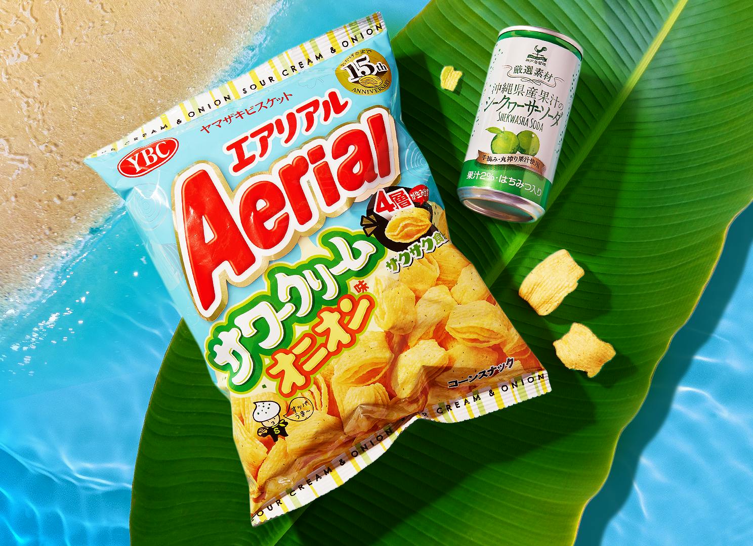Aerial Sour Cream & Onion Chips and Shikuwasa Soda sit on a palm tree on an Okinawan beach.