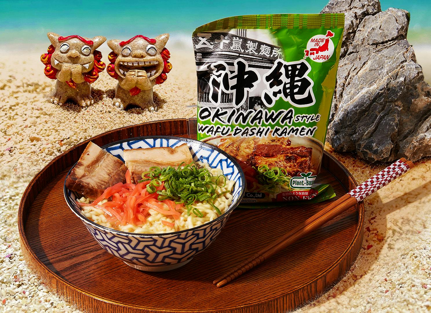 Okianwa Style Wafu Dashi Ramen sits on a wooden lacquer tray on a beach in Okinawa.