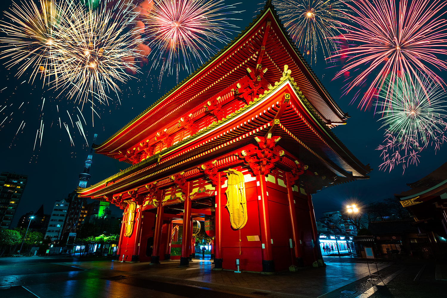 A view of Sensoji Temple's front gate in Asakusa, with fireworks overhead.
