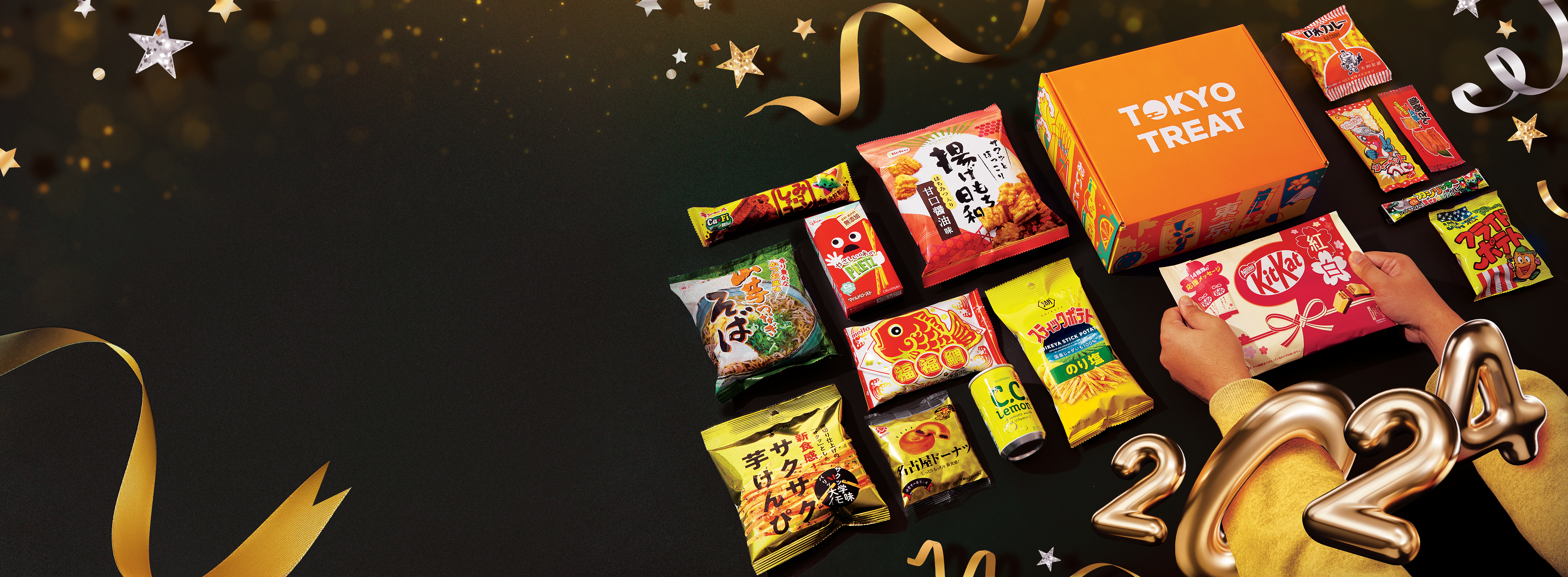 TokyoTreat box sits against a dark backdrop, surrounded by box items and New Year's motifs.