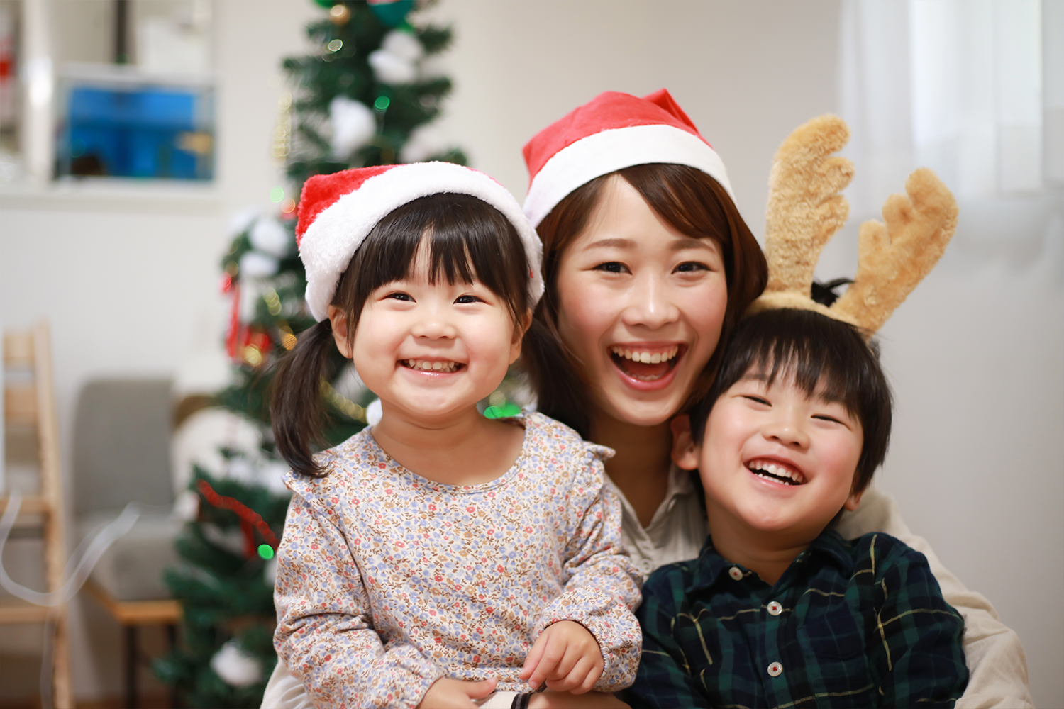 A Japanese family celebrates Christmas in Santa hats.