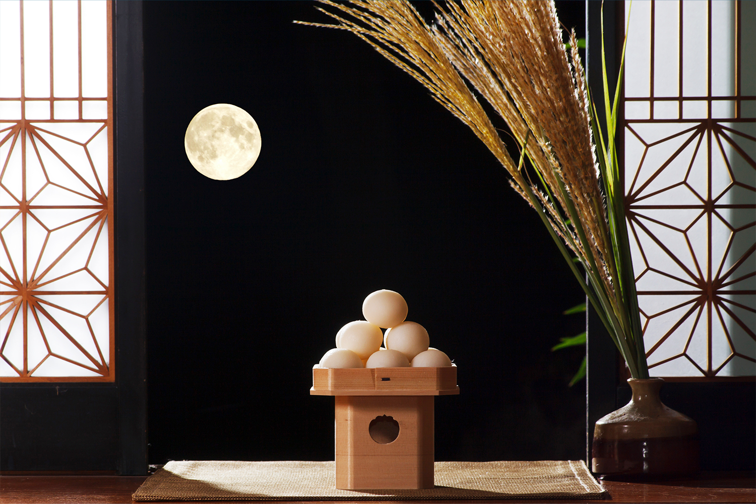 A Tsukimi scene with the moon, Tsukimi dango, and pampas grass.