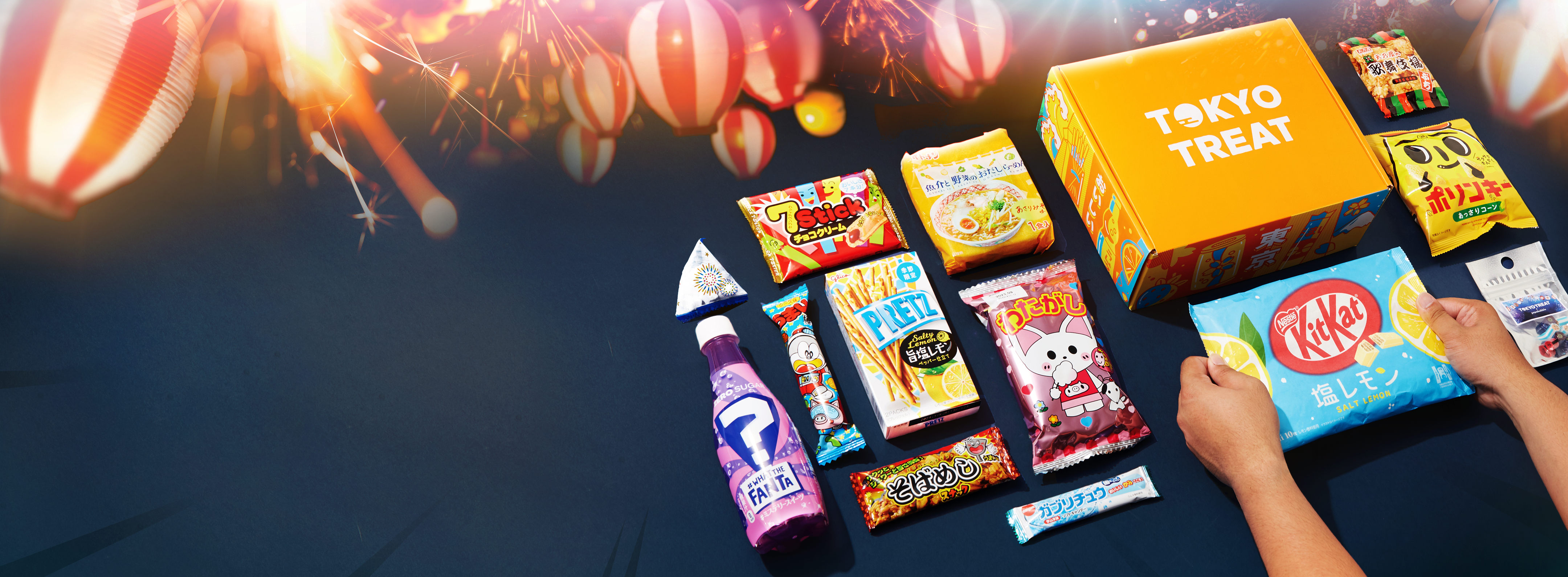 TokyoTreat box sits on a dark navy background, surrounded by Japanese festival lanterns.