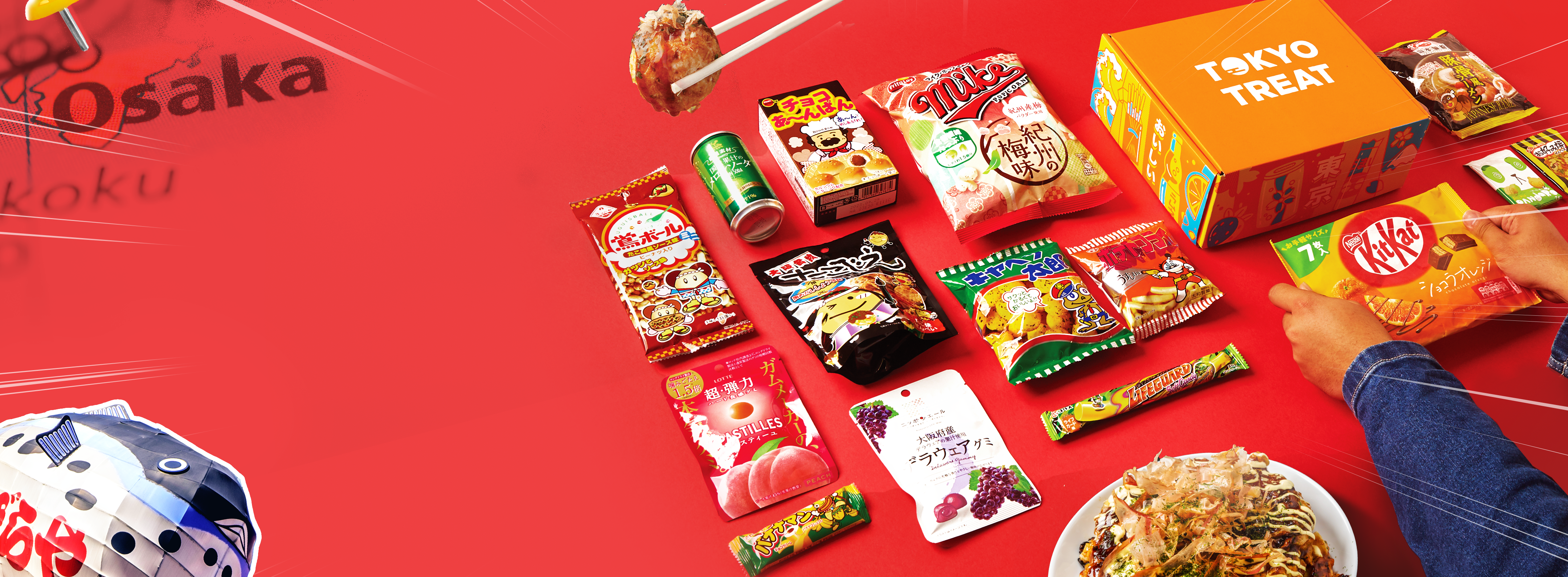 TokyoTreat box sits on a red background, surrounded by box items.