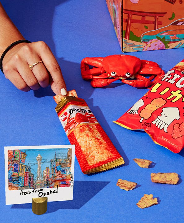 Squid tempura chips and the Dotonbori Crab Stick on a blue background.