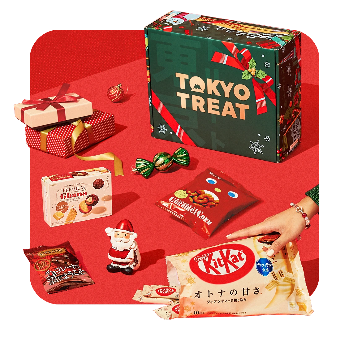 The TokyoTreat Very Merry Christmas box surrounded by incredible snacks from Japan!