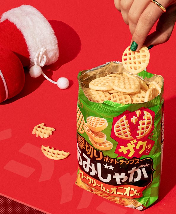 A bag of crispy sour cream & onion waffle chips against a red background.