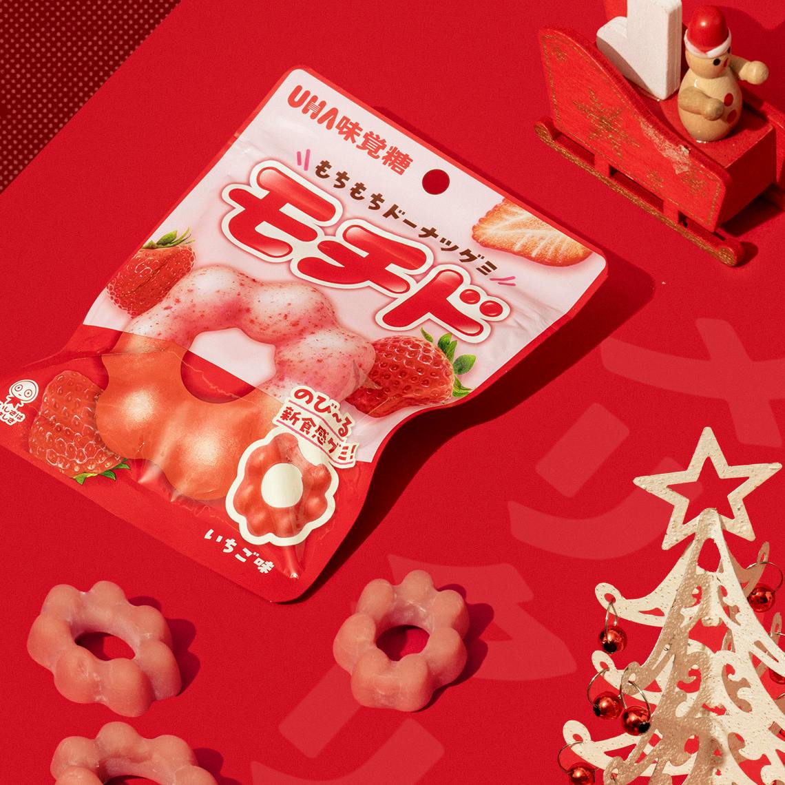 Gummies shaped like mochi donuts on a red background.