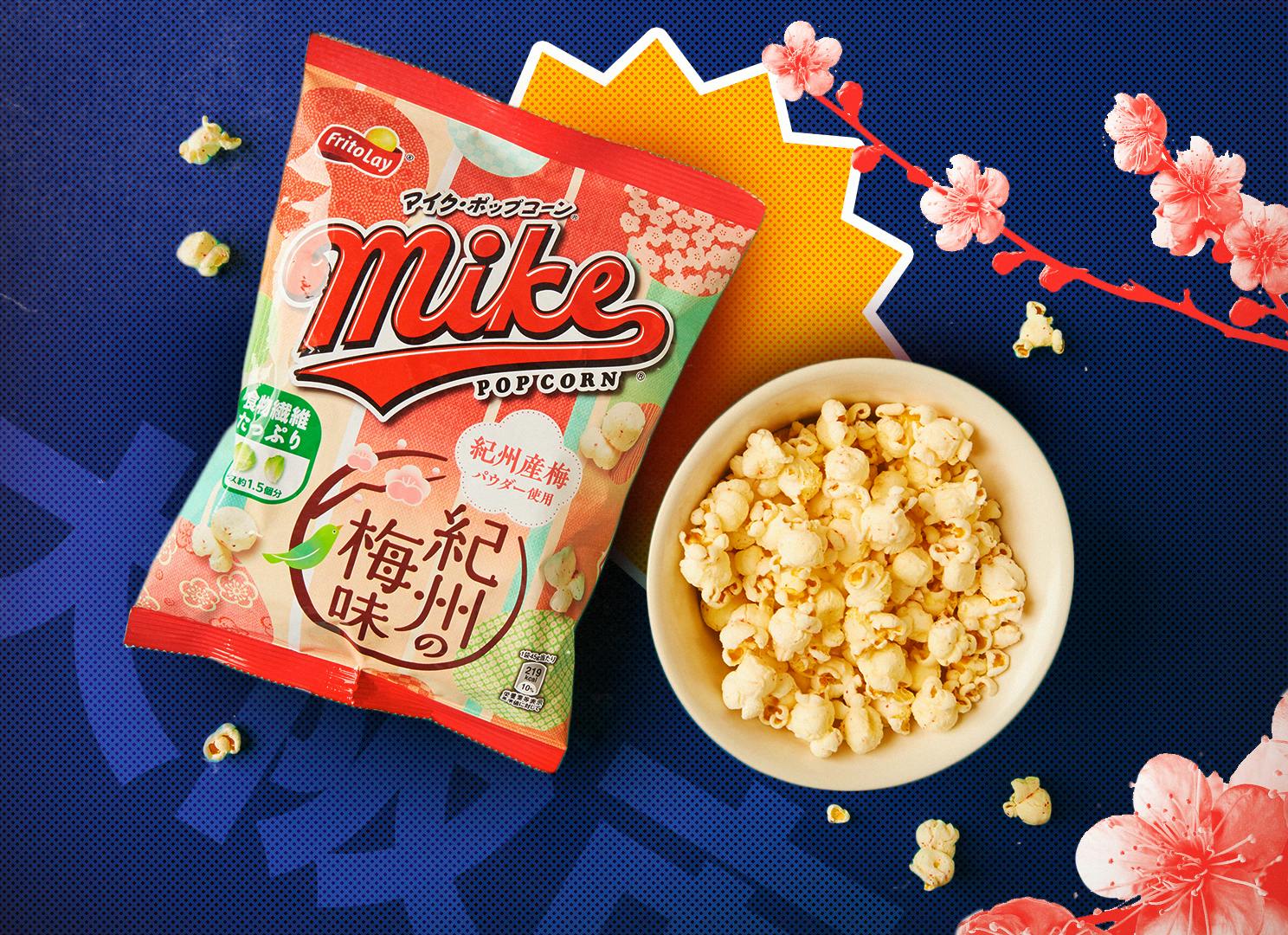 Kishu ume plum flavored Japanese popcorn is featured on a blue background surrounded by cherry blossoms