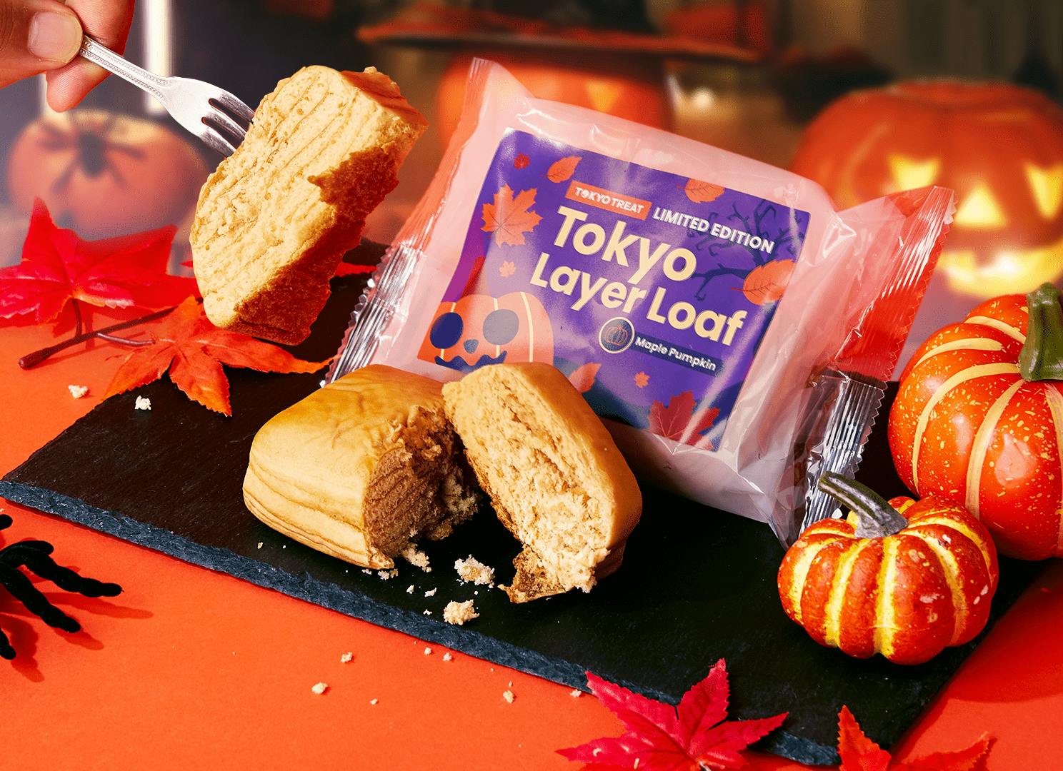A man eating Tokyo Layer Loaf sweet bread with pumpkin and maple at Halloween party. A man eating Tokyo Layer Loaf sweet bread with pumpkin and maple at Halloween party.