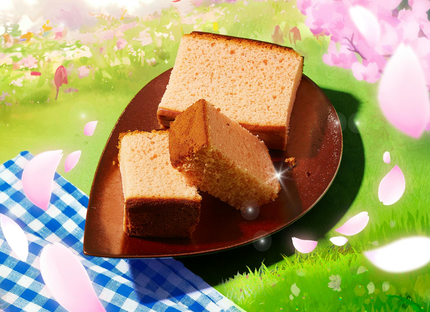 Sakura Castella Cake sits on a sakura petal plate against a hanami picnic backdrop.