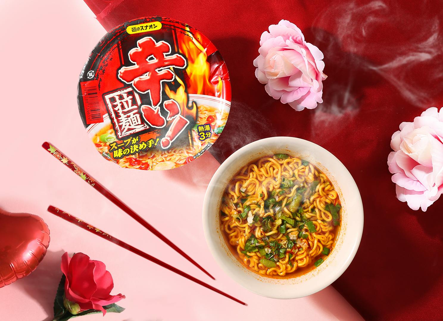 Spicy noodles are near pink flowers and red roses.