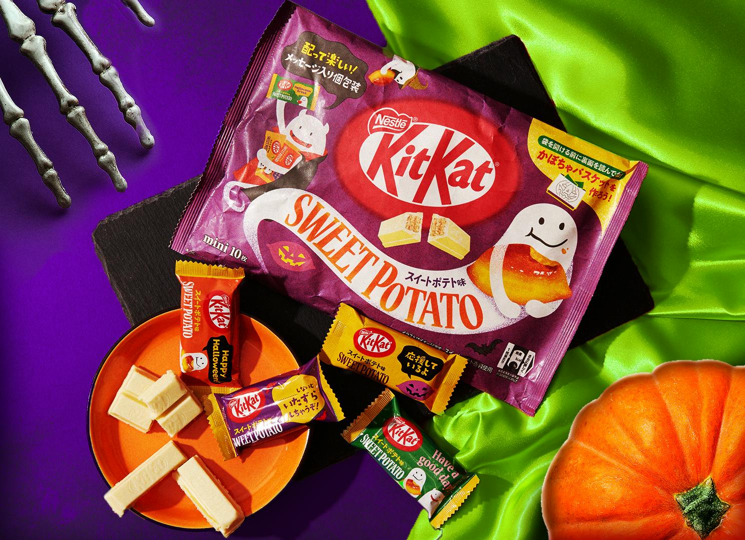 KitKat Sweet Potato item sits on a purple & electric green background, alongside other Halloween motifs like pumpkins and skeletons.