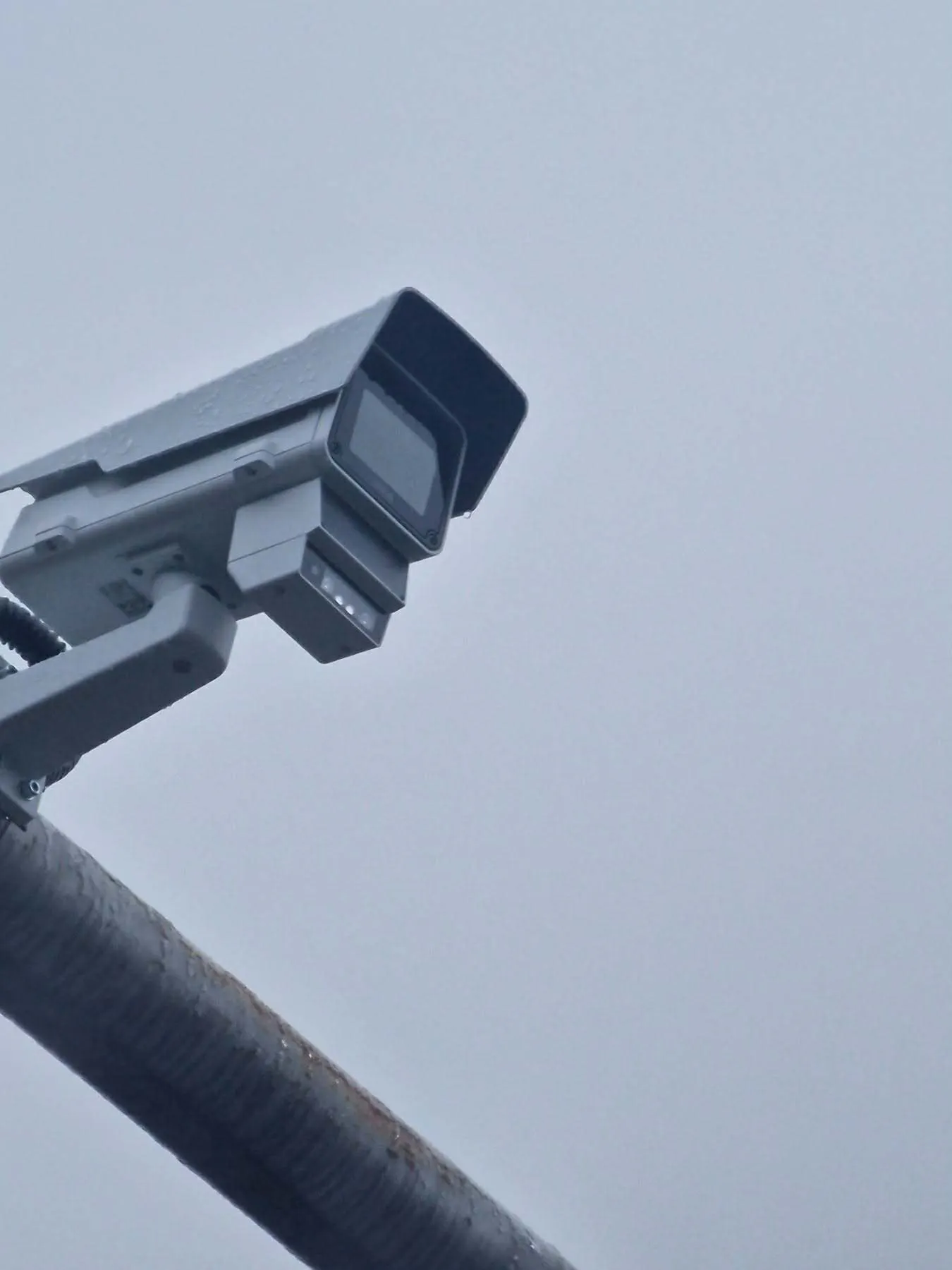 The camera mounted on a pole — a compact box that is easy to miss from the road