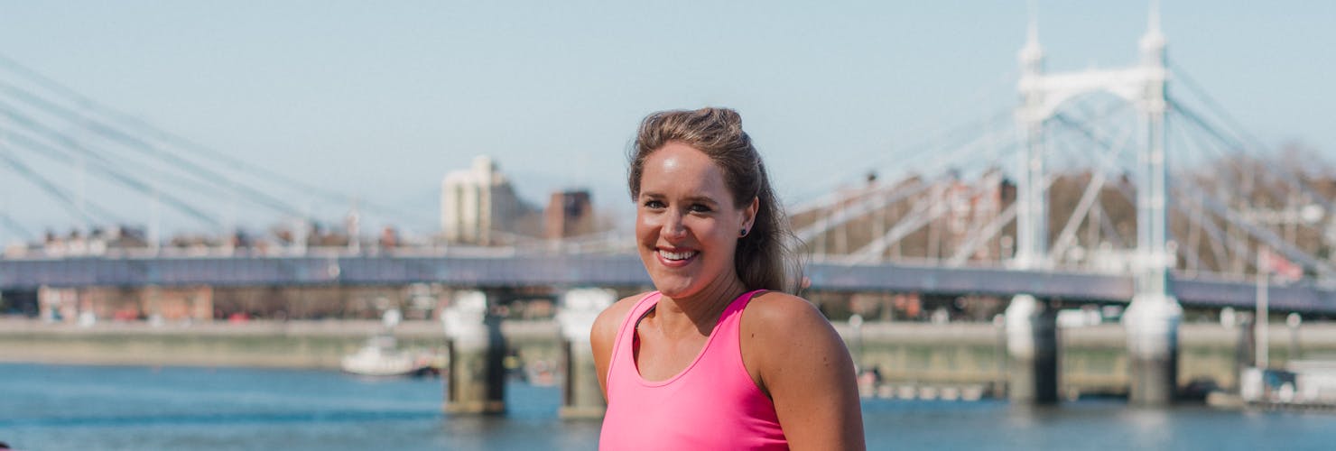 Lady posing in front of a bridge