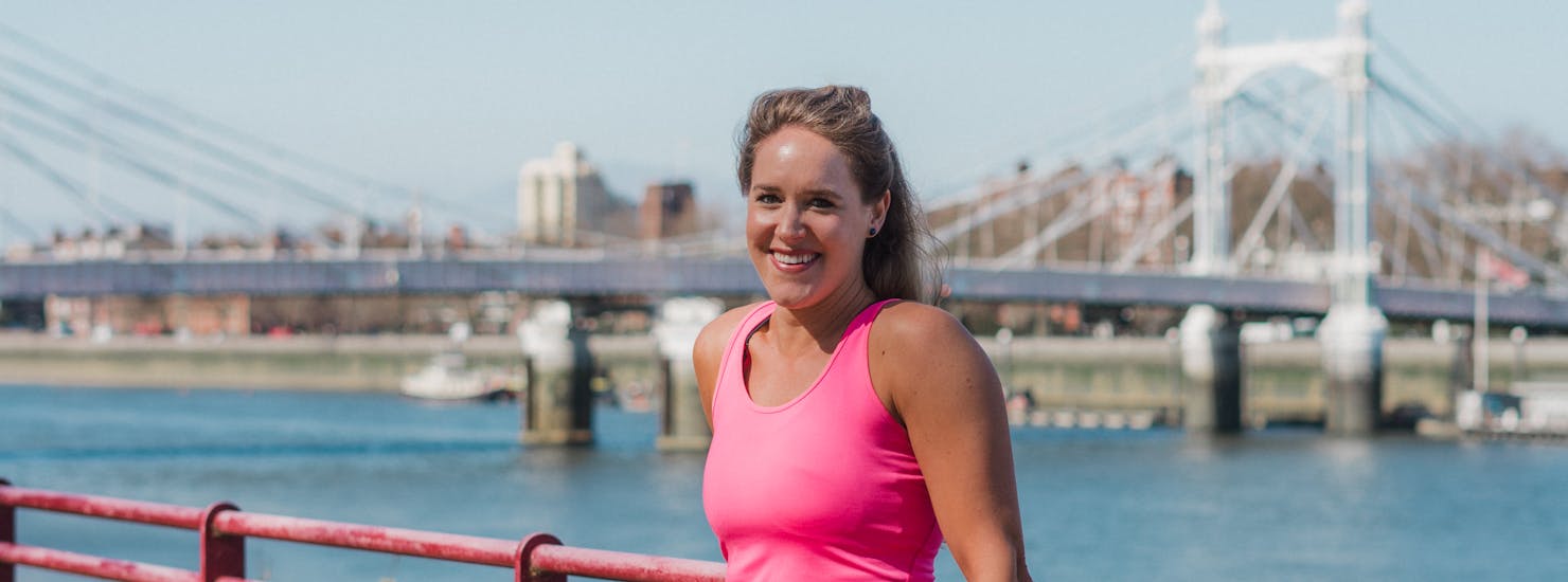 Lady posing in front of a bridge