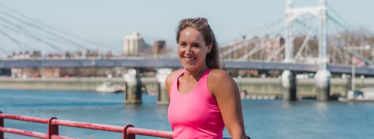 Lady posing in front of a bridge