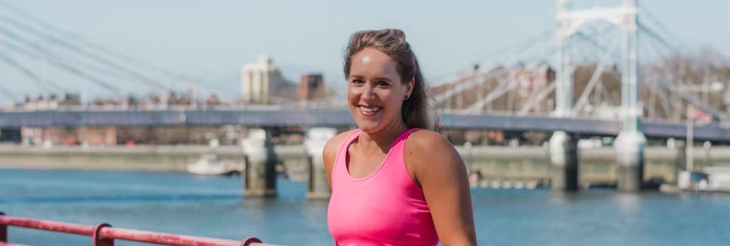 Lady posing in front of a bridge