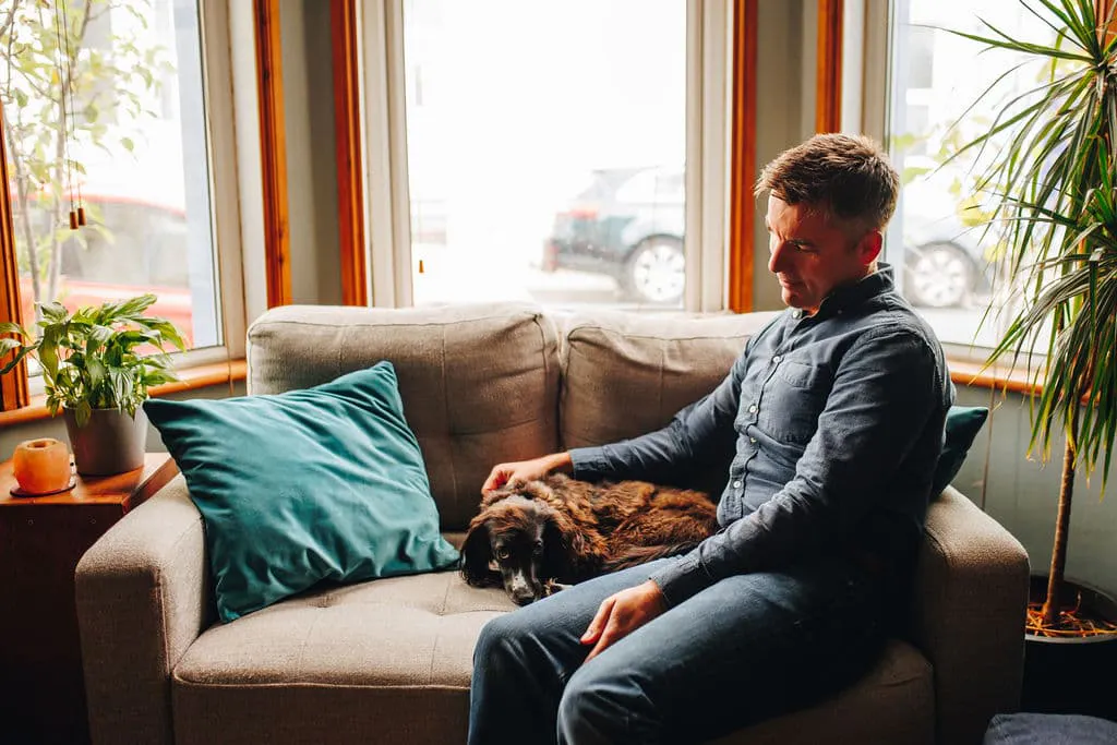 Tony with his dog scout on the couch