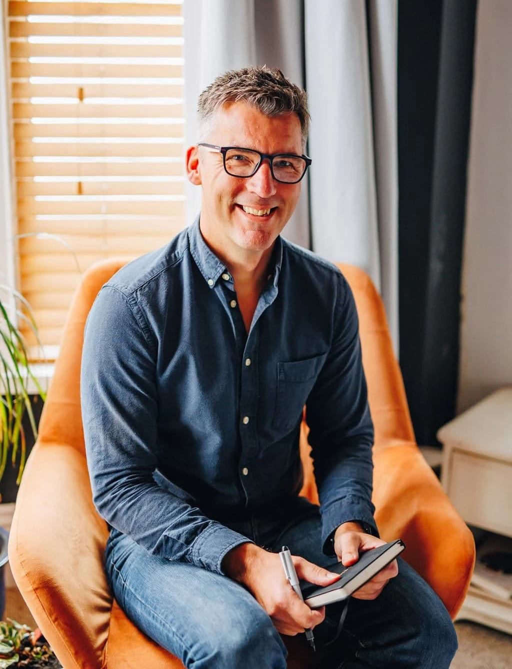 Tony Richardson sat in a chair smiling