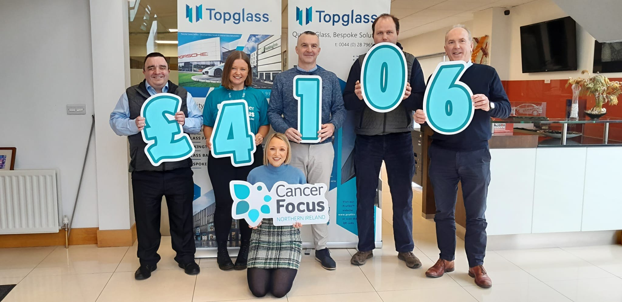 Team Topglass during funds handover with Cancer Focus NI 