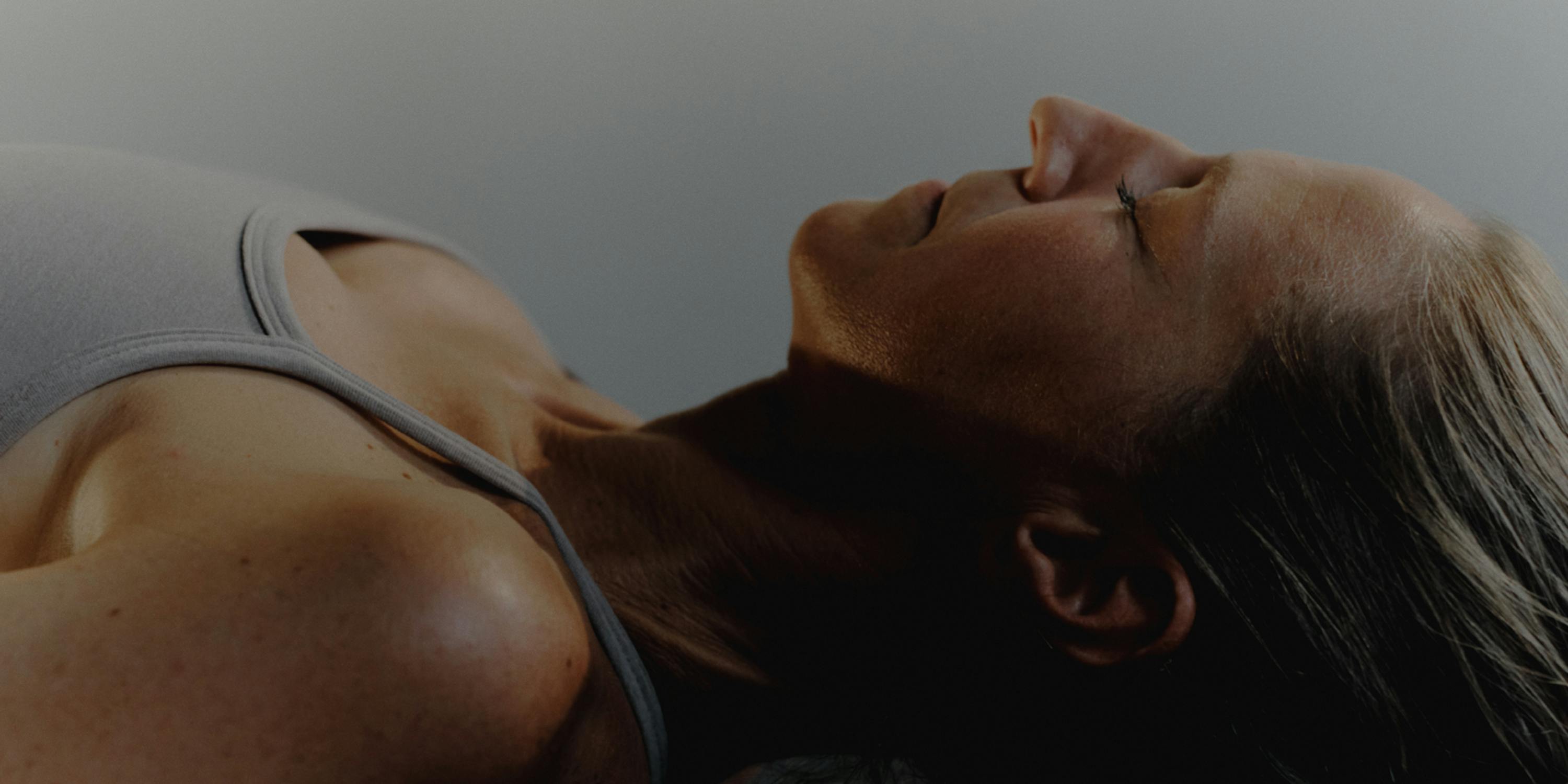 woman laying down in gym attire