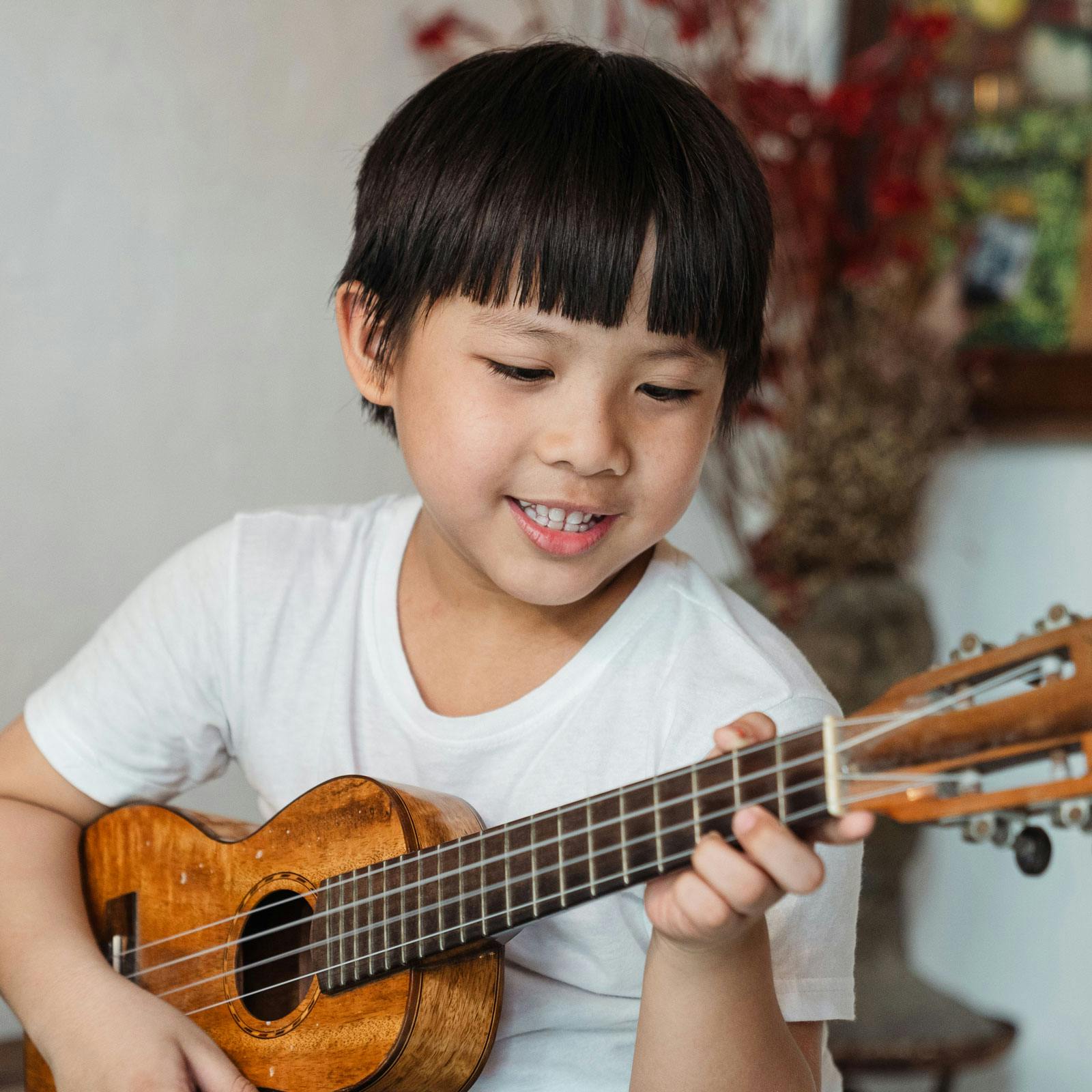Child playing ukulele