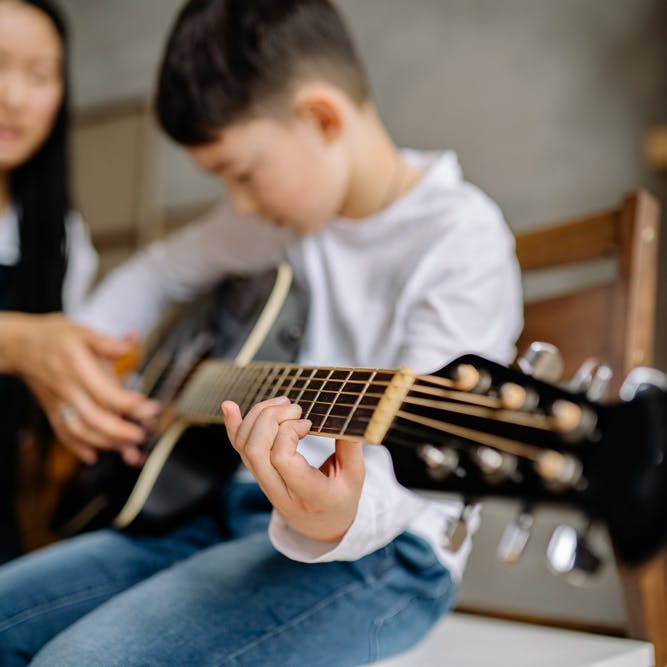 Child playing guitar