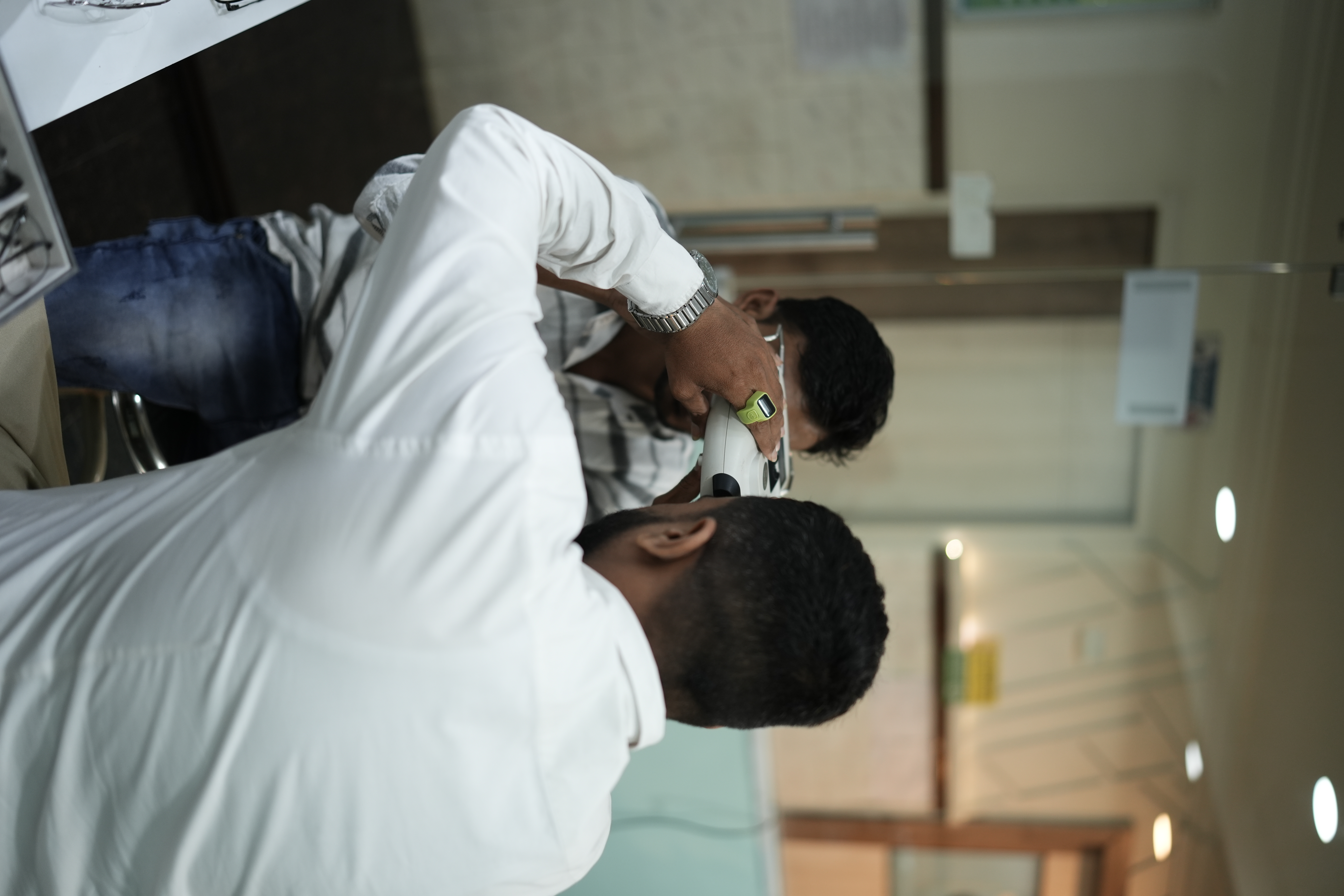 Eye clinic staff helping a patient with eyewear