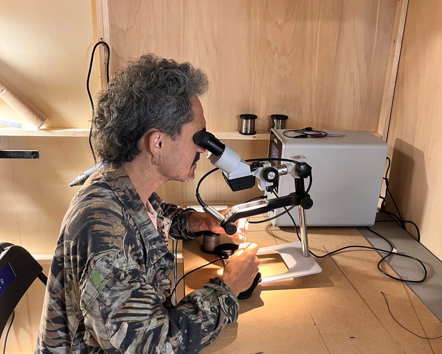 Worker looking in a microscope