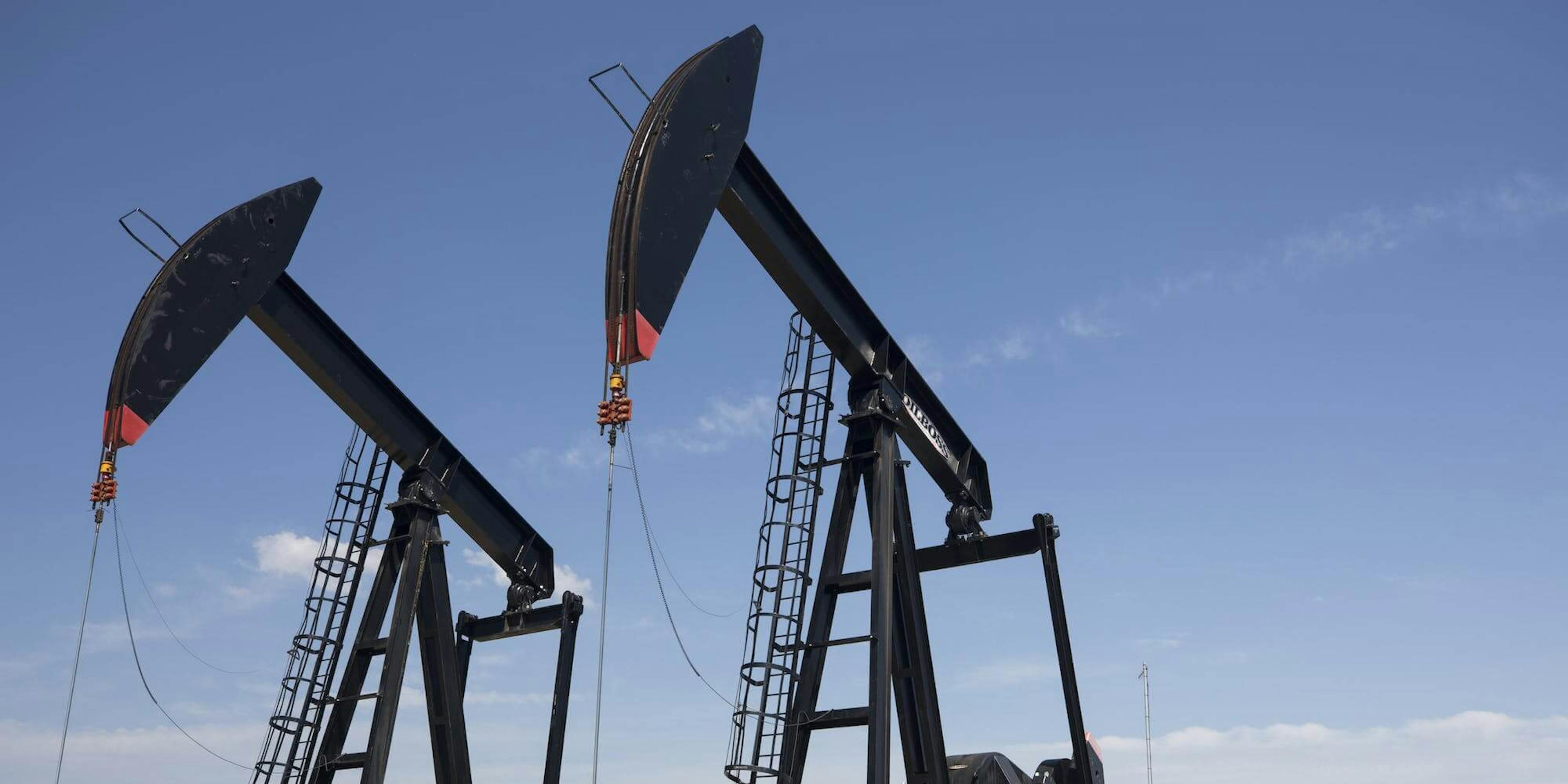 Two large oil pumps against a blue sky.