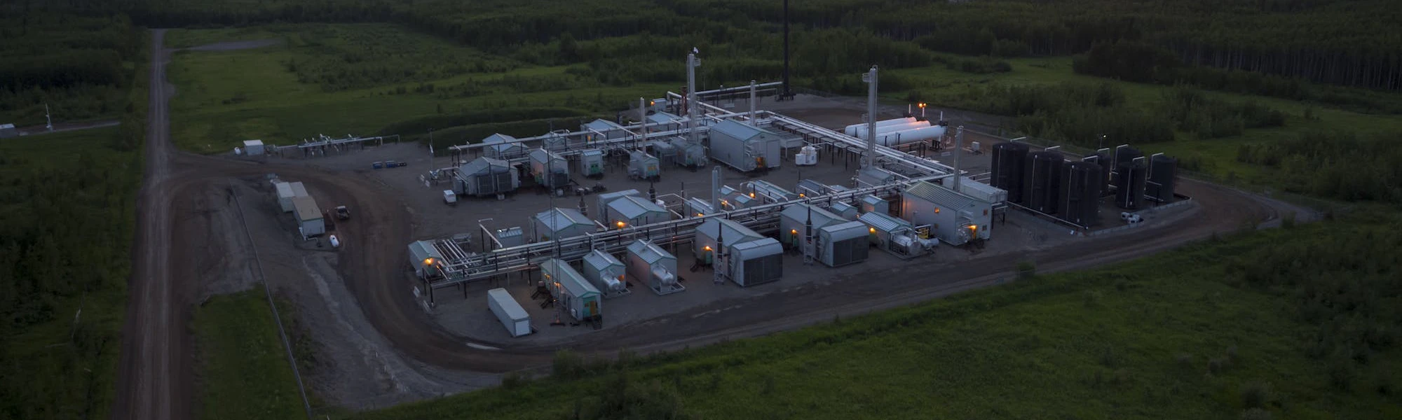An aerial view of a gas plant at sunrise.