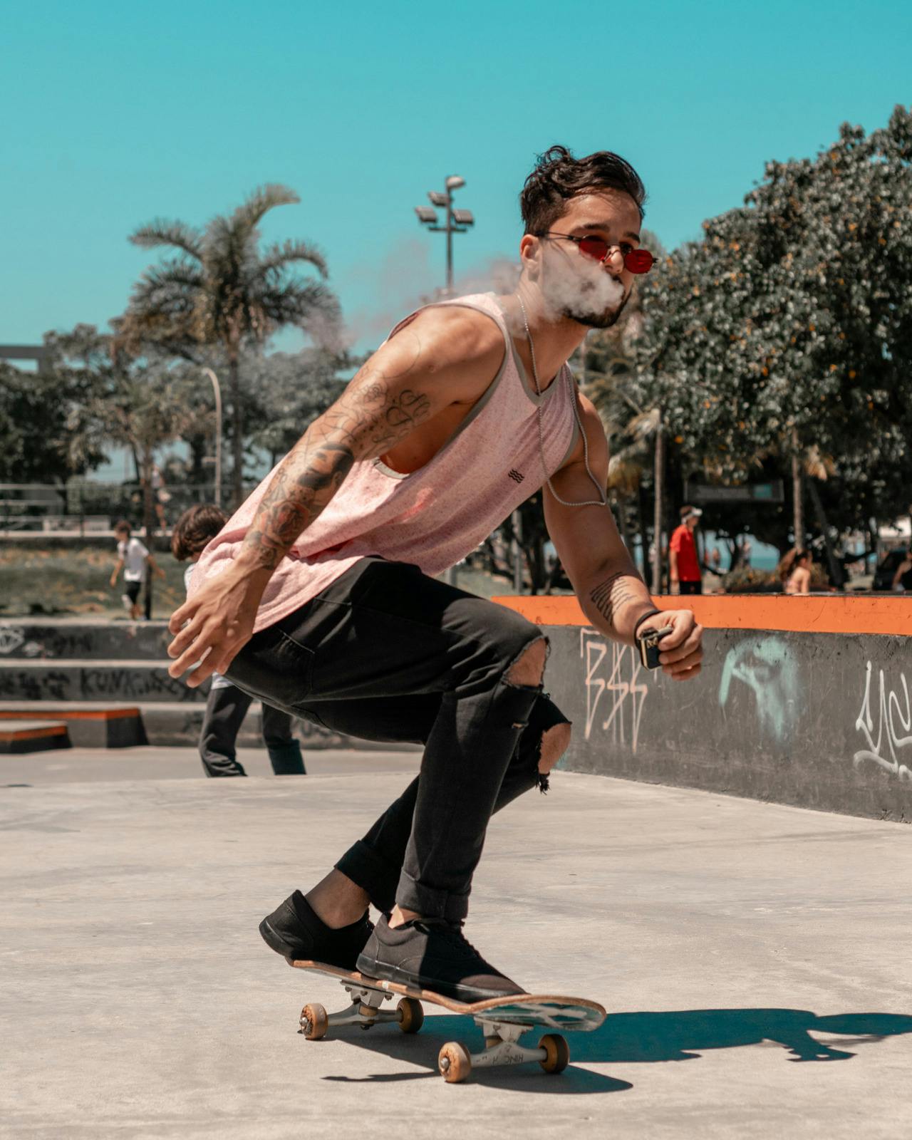 man vaping and skateboarding in urban setting 