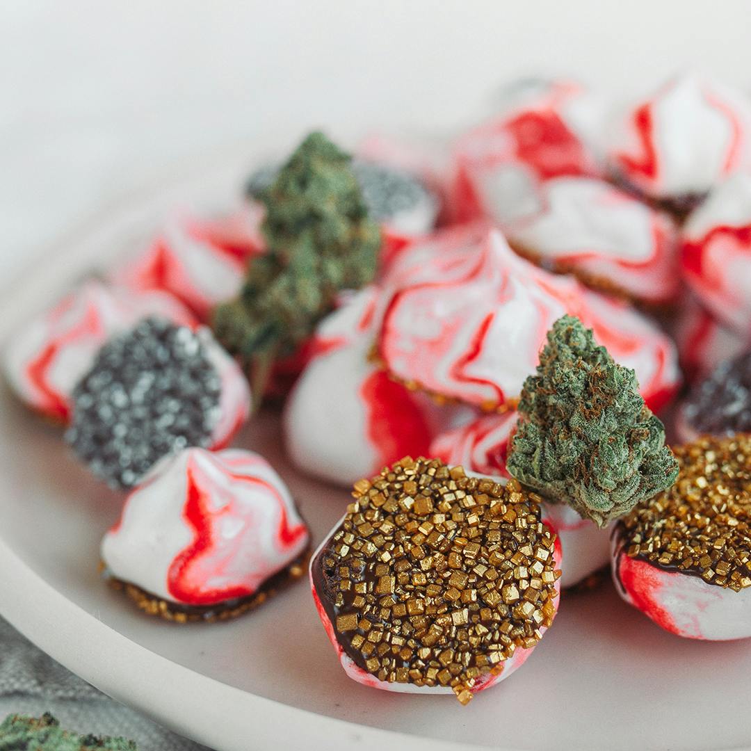 Weed-infused chocolate dipped peppermint meringues with cannabis flower.