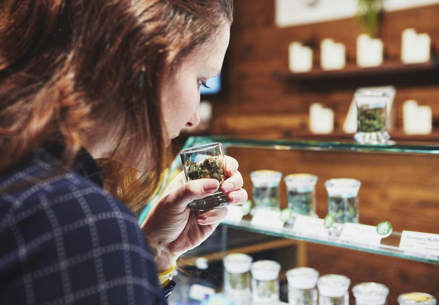 Woman smelling cannabis at Caliva's San Jose retail store.