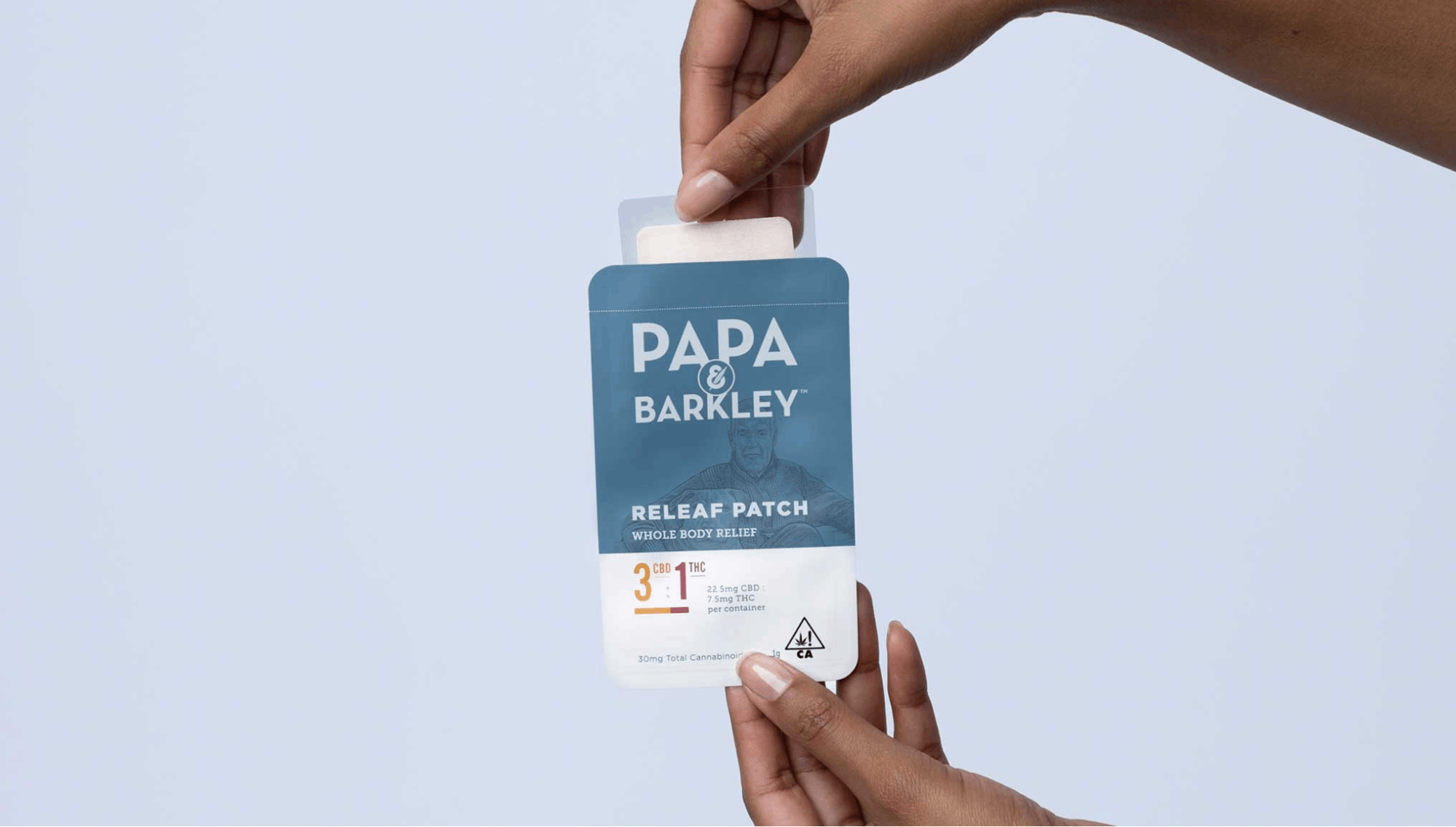 papa barkley releaf pactch held up by two hands 