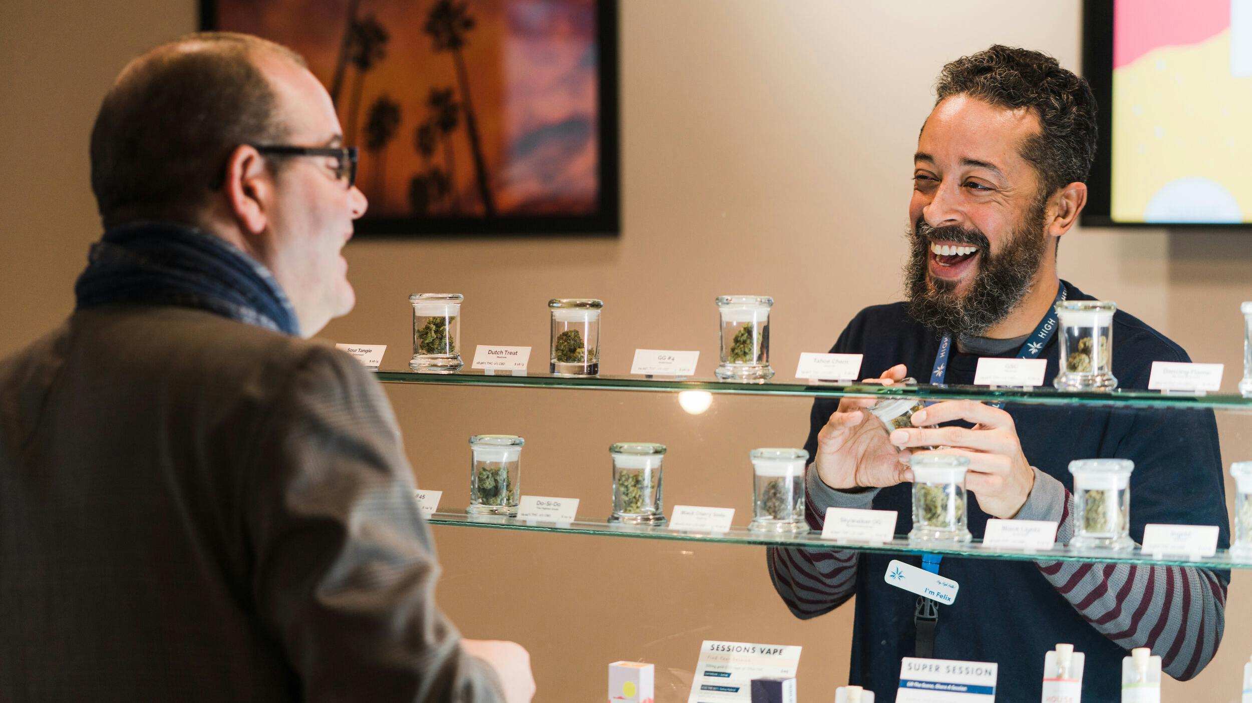 A male customer laughs with a budtender at the Caliva cannabis dispensary in San Jose, California.