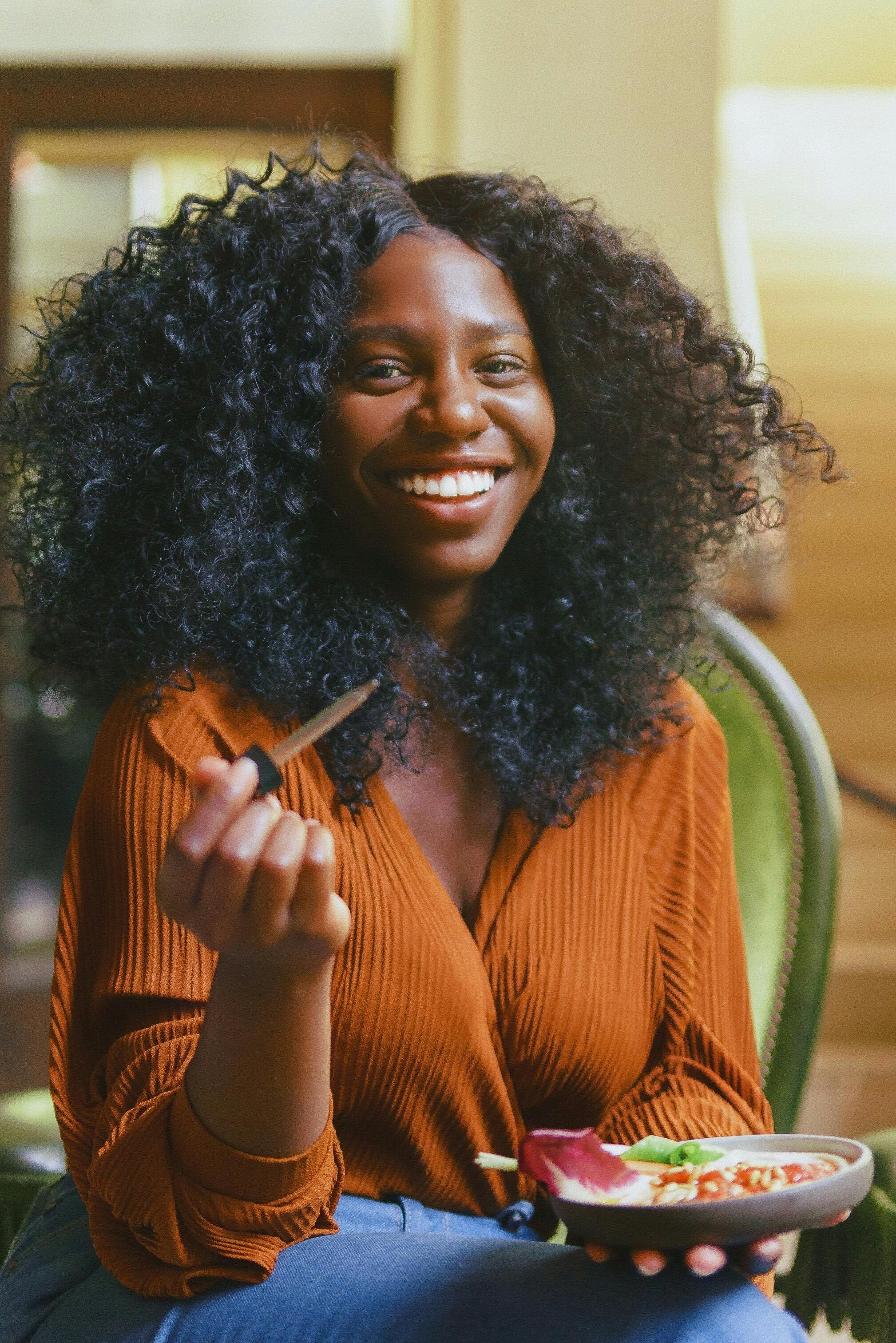 Woman smiling with a plate of food