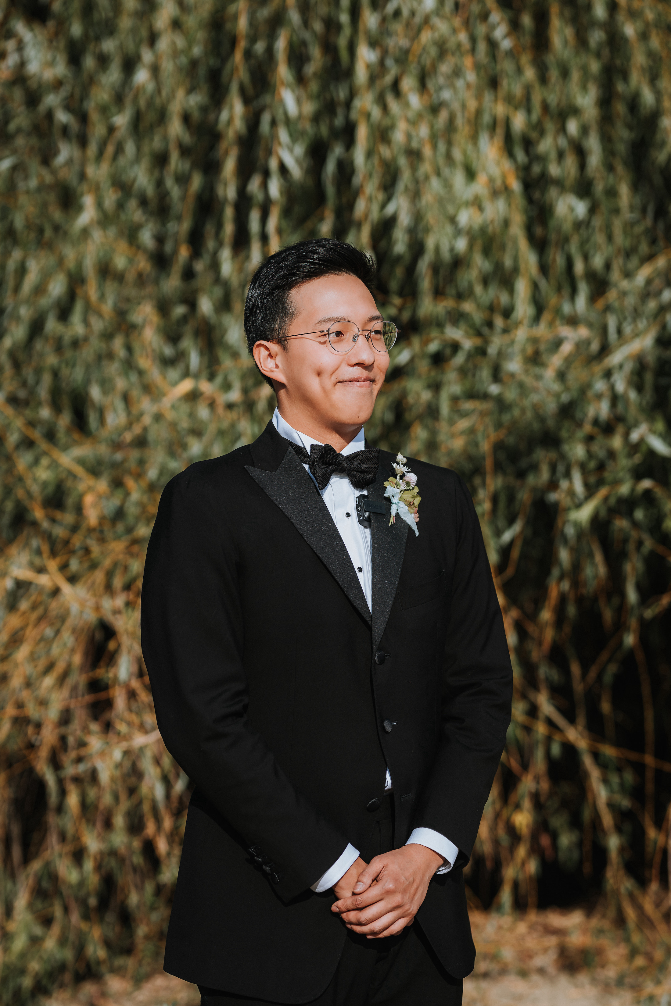 Groom smiling at the alter. 