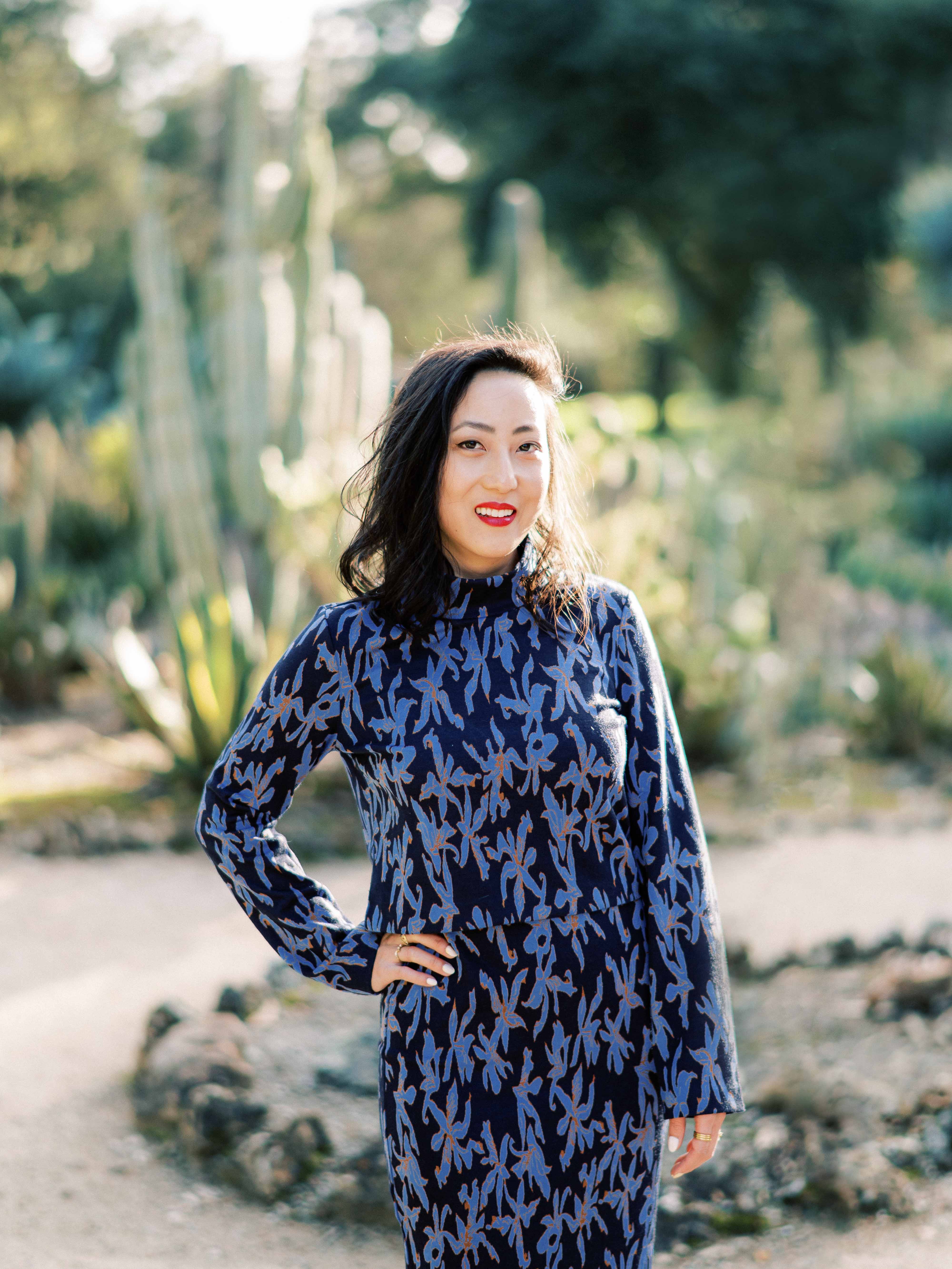 Woman smiling in cactus garden.