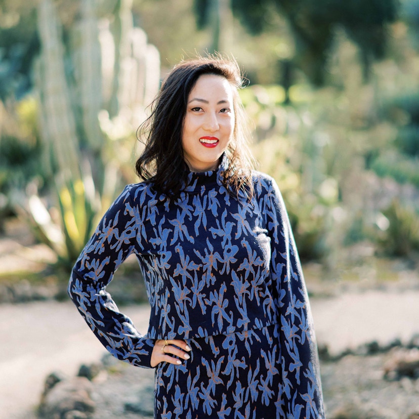 Woman smiling in cactus garden.